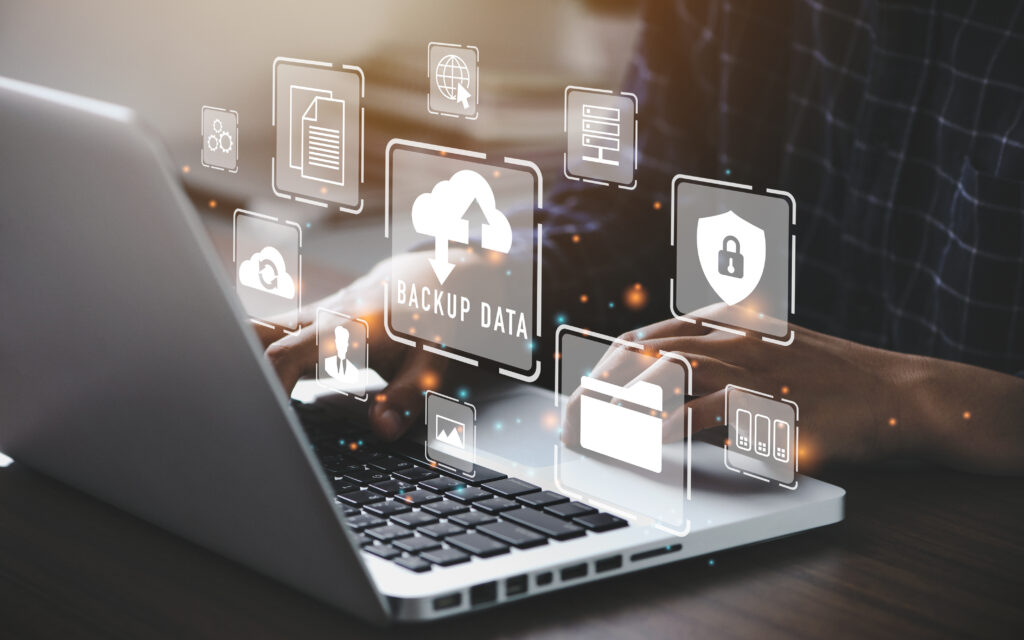 IT professional using a laptop to manage Office 365 cloud backup and data recovery